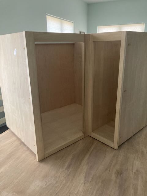 A corner cabinet pictured during assembly