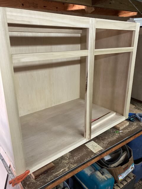 A wide storage cabinet pictured during assembly