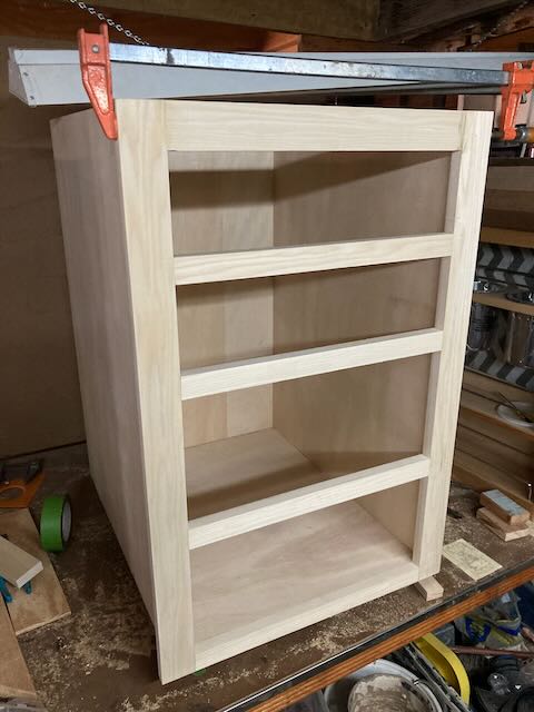 A four drawer cabinet pictured during assembly.
